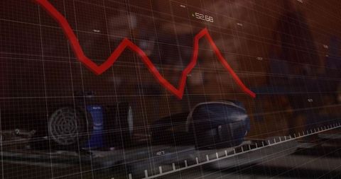 Declining financial chart over tech-infused workplace desk