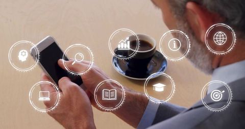 Senior Executive Holding Smartphone Tapping Screen with Business Analytics Icons and Coffee