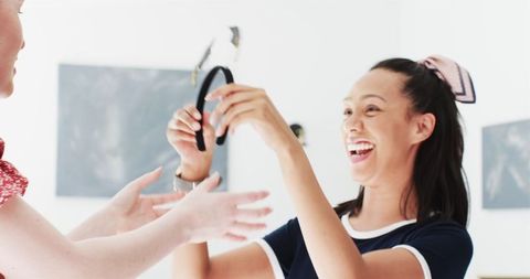 Diverse Graduates Celebrating Friendship Indoors with Energy