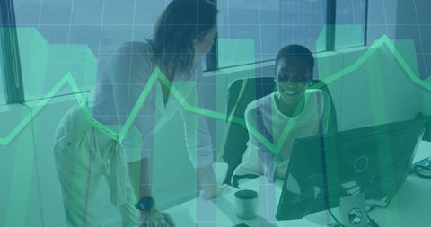 Business Women Collaborating Over Analytics in Modern Office