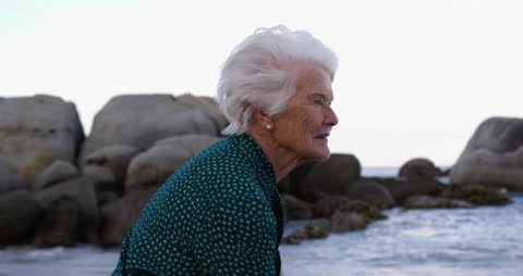 Thoughtful Senior Woman Enjoying Peaceful Beach View