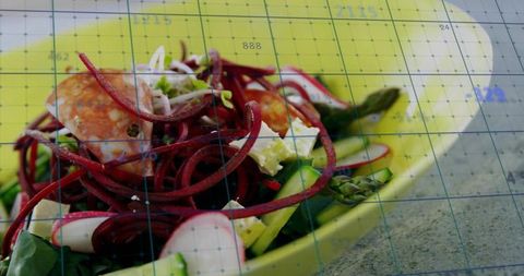 Vibrant beet spiral salad featuring asparagus, feta and radish in yellow bowl