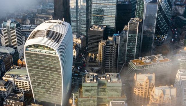 Aerial view curved walkie talkie tower and london financial district in morning mist