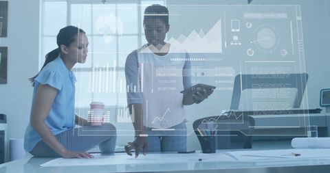 Business colleagues interacting with digital interface