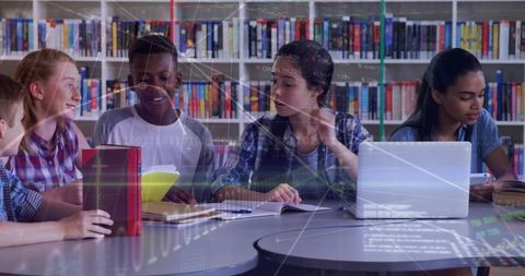 Teen Students Collaborating with Laptops and Notebooks in Library Learning Data Project