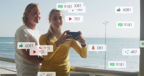 Couple Enjoying Beach Holiday with Social Media Notifications