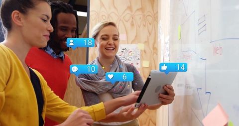 Diverse Team Engaging with Social Media in Creative Workspace