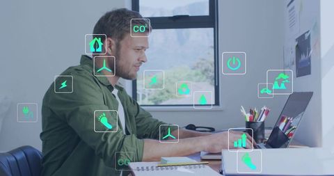 Man working on laptop with augmented energy analytics and sustainability icons dashboard