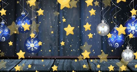 Festive blue silver baubles with golden stars on wooden background