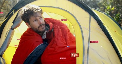 Man Relaxing in Sleeping Bag at Forest Campsite