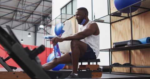 Man Resting at Gym While Practicing COVID-19 Safety Measures - Download Free Stock Images Pikwizard.com