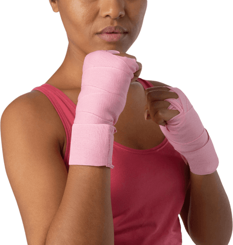 Confident woman wearing pink boxing wraps for breast cancer awareness