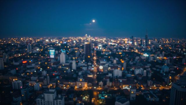 Blurred Urban Nightscape with Full Moon Over City Skyline