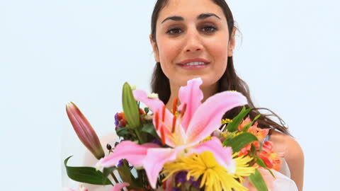 Smiling Woman Holding Lush Bouquet with Vibrant Flowers