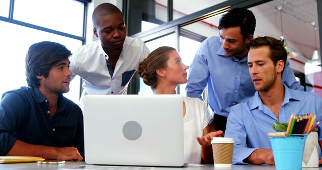 Diverse Colleagues Collaborating on Laptop in Modern Office Environment - Download Free Stock Images Pikwizard.com