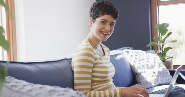 Smiling Woman Using Laptop Sitting on Sofa in Bright Home - Download Free Stock Images Pikwizard.com