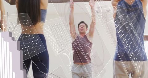 Male Trainer with Digital Fitness Interface Panels in Yoga Studio