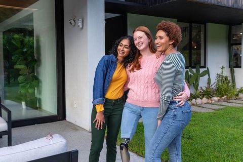 Diverse Friends Hugging Outdoors with Prosthetic Leg Visible