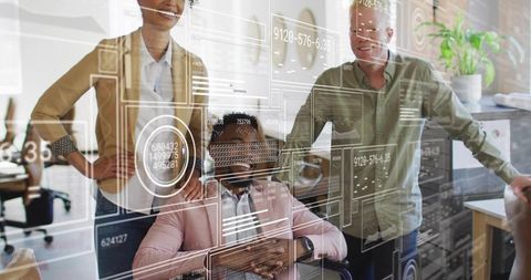 Inclusive team reviewing data with wheelchair user leading interactive dashboards