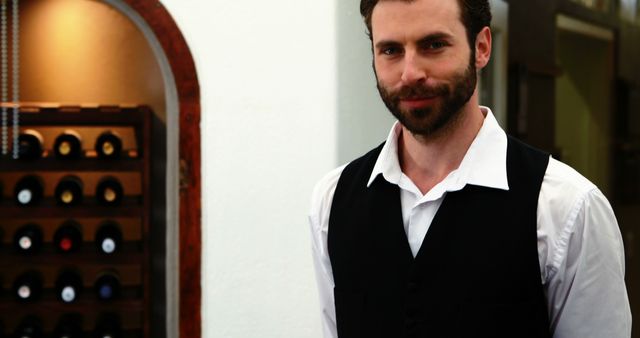 Confident Waiter in Uniform Standing in Restaurant Wine Cellar - Download Free Stock Images Pikwizard.com