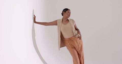 Stylish woman posing in minimalist studio setting