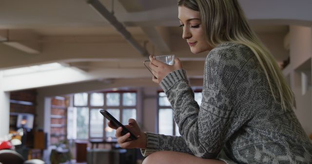 Woman Relaxing at Home Using Smartphone and Drinking Coffee - Download Free Stock Images Pikwizard.com