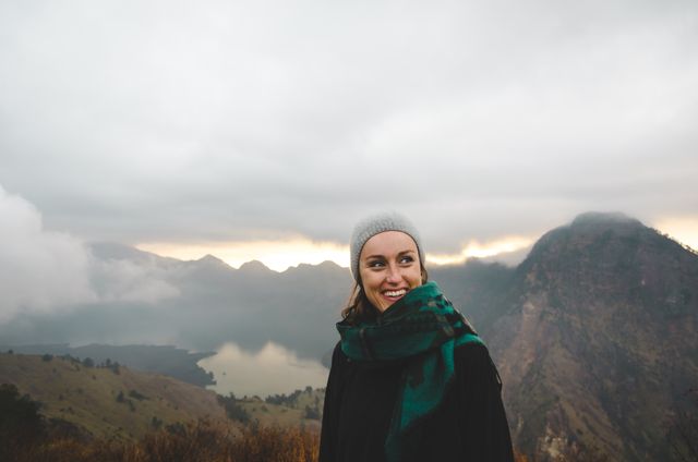 Woman Hiking in Mountainous Landscape During Cloudy Sunrise - Download Free Stock Photos Pikwizard.com