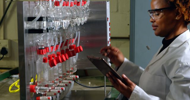 Female Scientist Conducting Laboratory Experiment Using Tablet - Download Free Stock Images Pikwizard.com