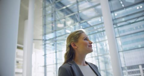 Businesswoman smiling in modern sunlit office space