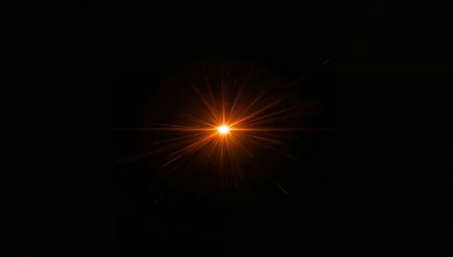 Radiating orange starburst flare with halo and diffraction rays on black void