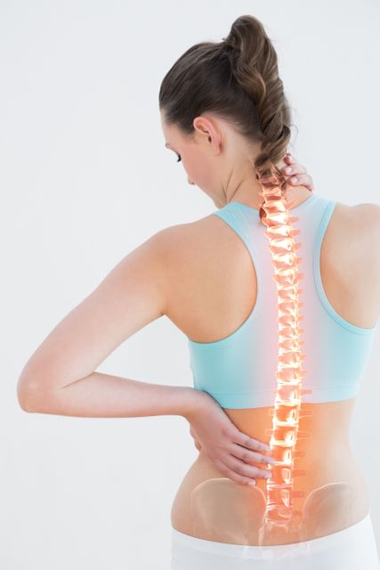 Woman Experiencing Back Pain Holding Lumbar Region - Download Free Stock Photos Pikwizard.com