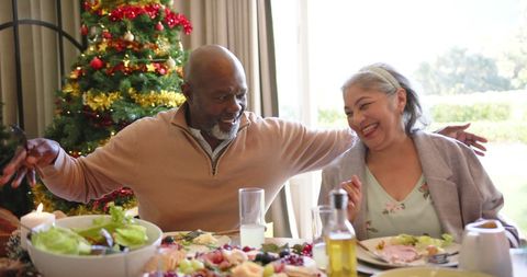 Joyful Senior Couple Enjoying Christmas Dinner Together