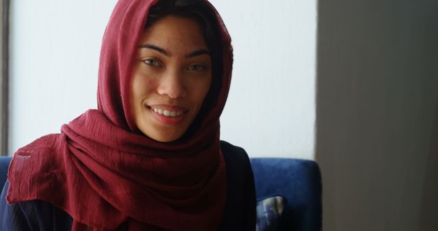 Smiling Young Woman in Red Hijab Looking at Camera Indoors - Download Free Stock Images Pikwizard.com