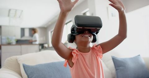 Enthusiastic Child Engaging with Virtual Reality at Home
