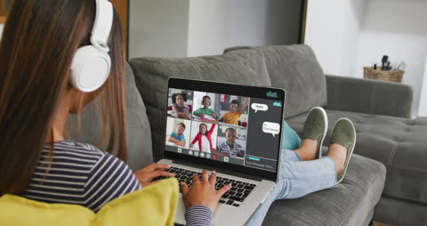Girl Relaxing on Couch Using Laptop for Remote Learning Session