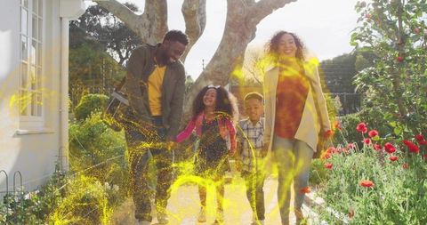 Family Walking Together in Scenic Garden with Magical Lights