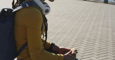 Young Woman with Headphones Relaxing at Waterfront