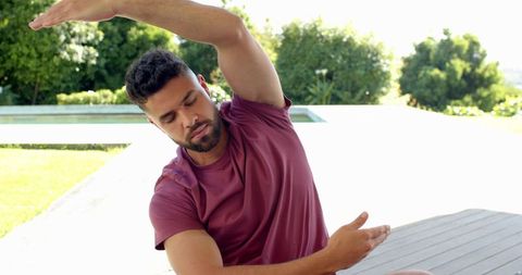 Man Practicing Outdoor Yoga by Pool in Summer