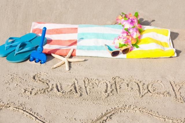 Beach accessories and summer Witten on sand at beach