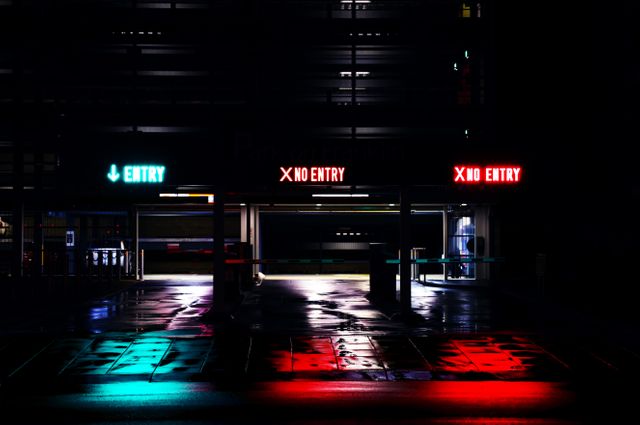 Colorful neon signs illuminate parking garage entrances and exits seen at night. Vibrant reflections on wet pavement create a dramatic cityscape. Ideal for use in advertisements for urban life, city planning, or modern lifestyle. This can also be used for presenting nightlife themes or parking-related content in urban settings.