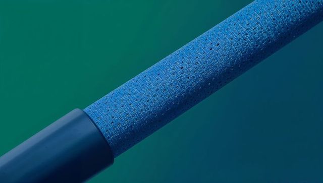 Textured blue foam grip running diagonal on teal to navy gradient with dark endcap