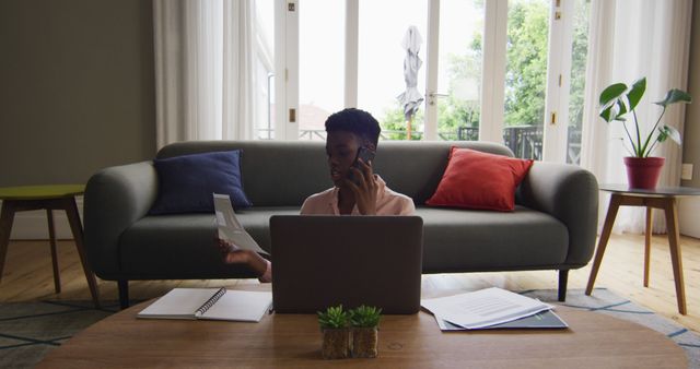 African American Woman Discussing Finances Over Phone While Telecommuting - Download Free Stock Images Pikwizard.com