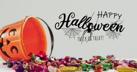 Spooky Halloween Candy Overflow with Pumpkin Bucket on Grey Background - Download Free Stock Images Pikwizard.com