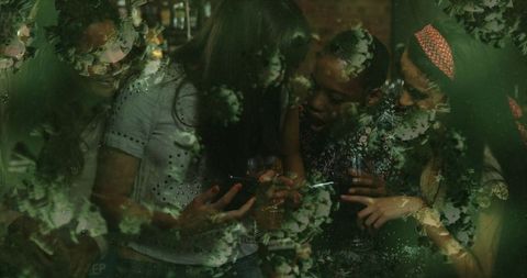 Digital overlay of floating cells over club scene with diverse friends