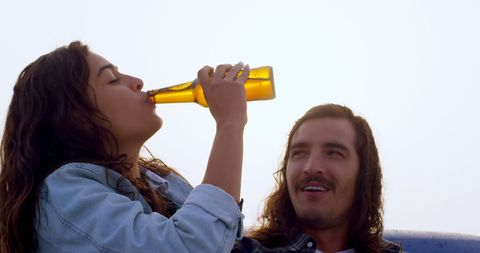 Young Adults Enjoying Leisure Outdoors with Refreshing Drinks