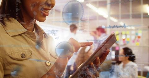Holding tablet in open office using touchscreen for data visualization and analytics dashboard