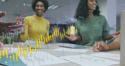 Collaborating team analyzing business charts and colorful data visualization overlay