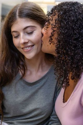 Tender Moment: Affectionate Kiss on Cheek in Cozy Home