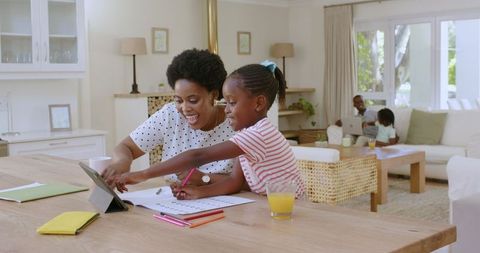 Mother and Daughter Engaging in Art Activity at Home