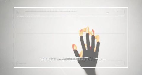 Reaching shadow hand casting glowing fingertips with hud overlay minimal tech interface